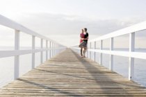 Young couple kissing on pier — Stock Photo