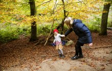 Playful mother and daughter in forest — Stock Photo