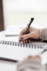 Hand writing in spiral notebook — Stock Photo