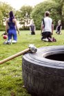 Hammer and tire at park — Stock Photo