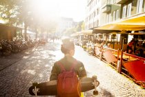 Rear view of woman with skateboard — Stock Photo