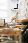 Male chef stirring gravy — Stock Photo