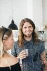 Happy young man holding drinking glass — Stock Photo