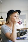 Young woman having drink — Stock Photo