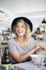 Woman sitting at table in restaurant — Stock Photo
