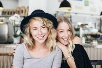 Young woman with friend in restaurant — Stock Photo