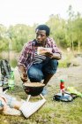 Man holding sausages while barbecuing — Stock Photo