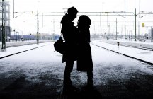 Silhouette couple standing on platform — Stock Photo