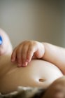 Baby lying against wall — Stock Photo