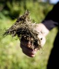 Person holding roots — Stock Photo