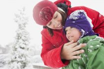 Mère avec fils s'amuser dans la neige — Photo de stock