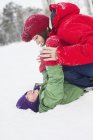Мать с сыном веселятся в снегу — стоковое фото