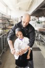 Шеф-повар помогает мальчику — стоковое фото