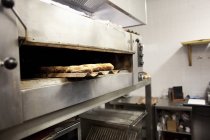 Baguette breads on baking sheet — Stock Photo