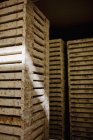 Weathered crates in dark room — Stock Photo