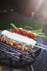 Vegetables and cheese being grilled on barbecue — Stock Photo