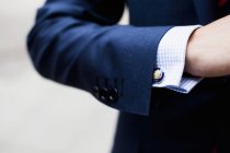 Businessman wearing cuff link — Stock Photo