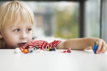 Cute boy playing with toys — Stock Photo