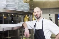 Chef standing at commercial kitchen — Stock Photo