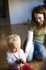 High angle view of smiling mother playing with son at home — Stock Photo