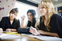 Female students studying at desk in classroom — Stock Photo
