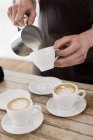 Barista making cappuccino — Stock Photo