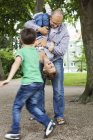Playful father and sons — Stock Photo