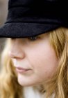 Portrait of thoughtful woman wearing black cap — Stock Photo