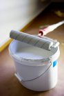 Paint roller on can at home — Stock Photo