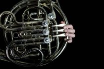 Hands playing French horn — Stock Photo