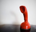 Orange scandiphone on table — Stock Photo