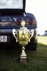 Trophy in front of car — Stock Photo