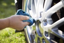 Hand cleaning car tire — Stock Photo