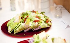 Wraps in plate on dining table — Stock Photo