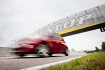 Car passing under bridge — Stock Photo
