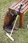 Polo mallet and boots — Stock Photo