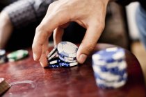 Hand holding poker chips — Stock Photo