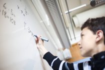 Schoolboy solving mathematics — Stock Photo