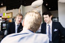 Les hommes d'affaires discutent avec un collègue — Photo de stock