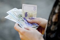 Woman holding Danish banknotes — Stock Photo