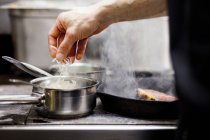 Chef cooking at commercial kitchen — Stock Photo