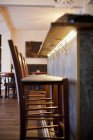 Bar stools at counter in restaurant — Stock Photo