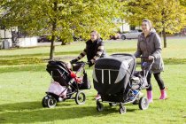 Women walking with baby carriages — Stock Photo