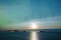 Northern light above sea — Stock Photo