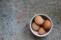 Overhead view of eggs in bowl — Stock Photo