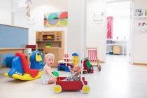 Baby playing with toys at horizontal — Stock Photo