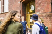 Students talking by school — Stock Photo