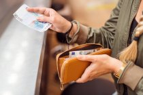 Woman paying with cash at bar — Stock Photo
