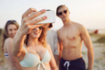 Teenage girl taking selfie on beach — Stock Photo