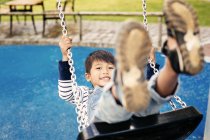 Boy on swing, close-up — Stock Photo